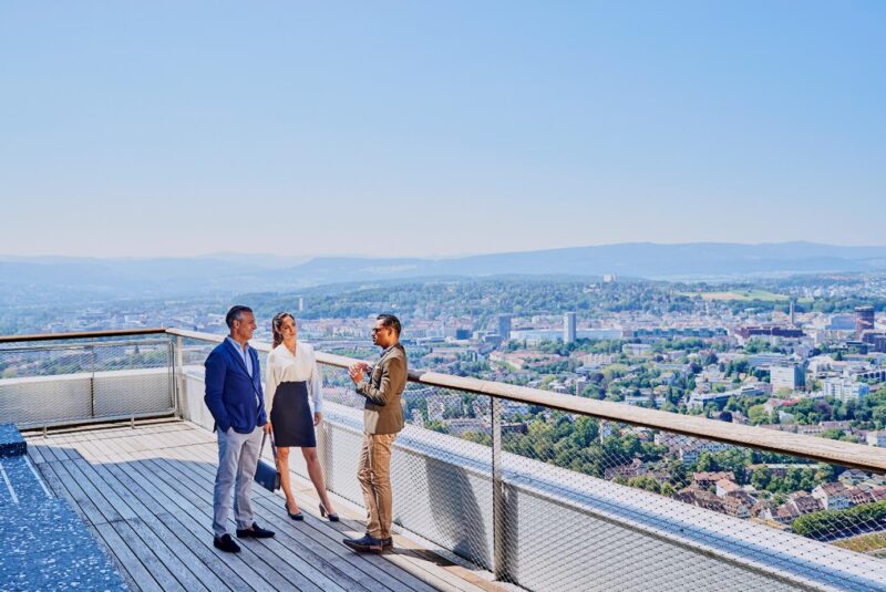 Business people talking on top of Roche tower